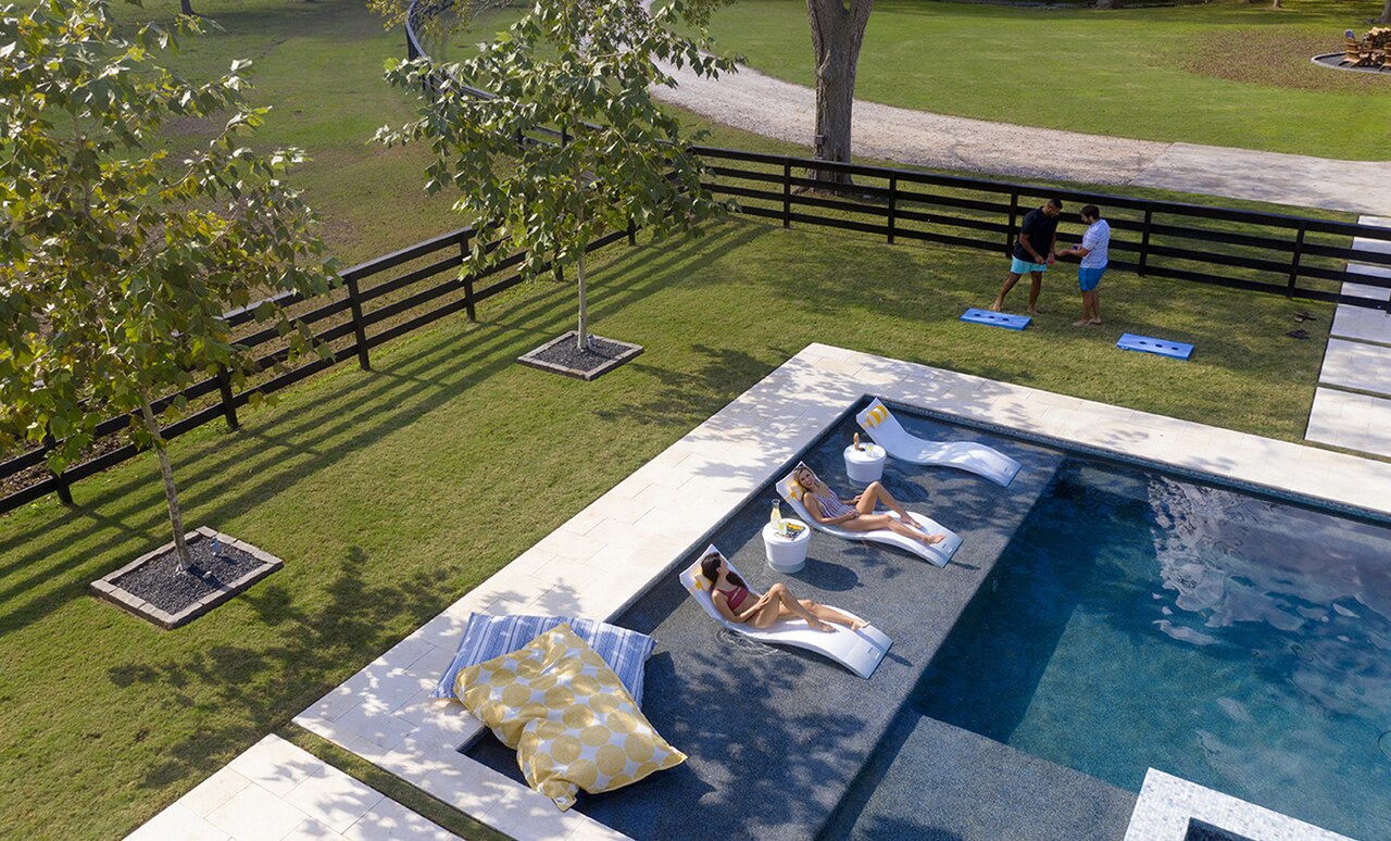 people lounge on a tanning ledge lounger