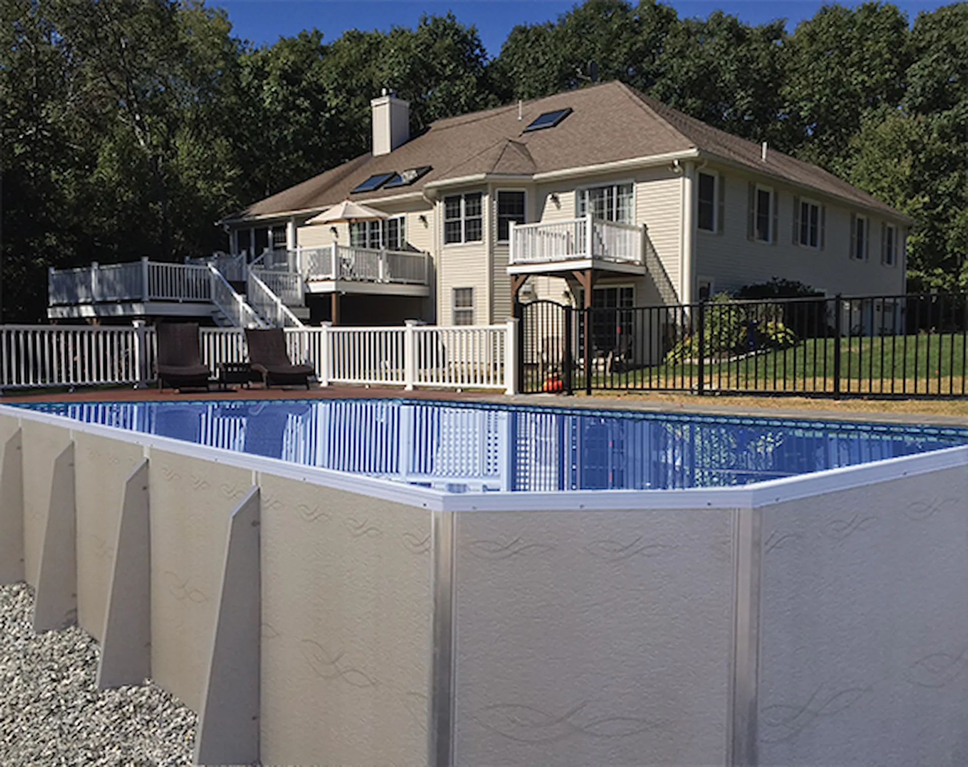 A rectangular above ground swimming pool sits in a fenced backyard of a Pennsylvania home.